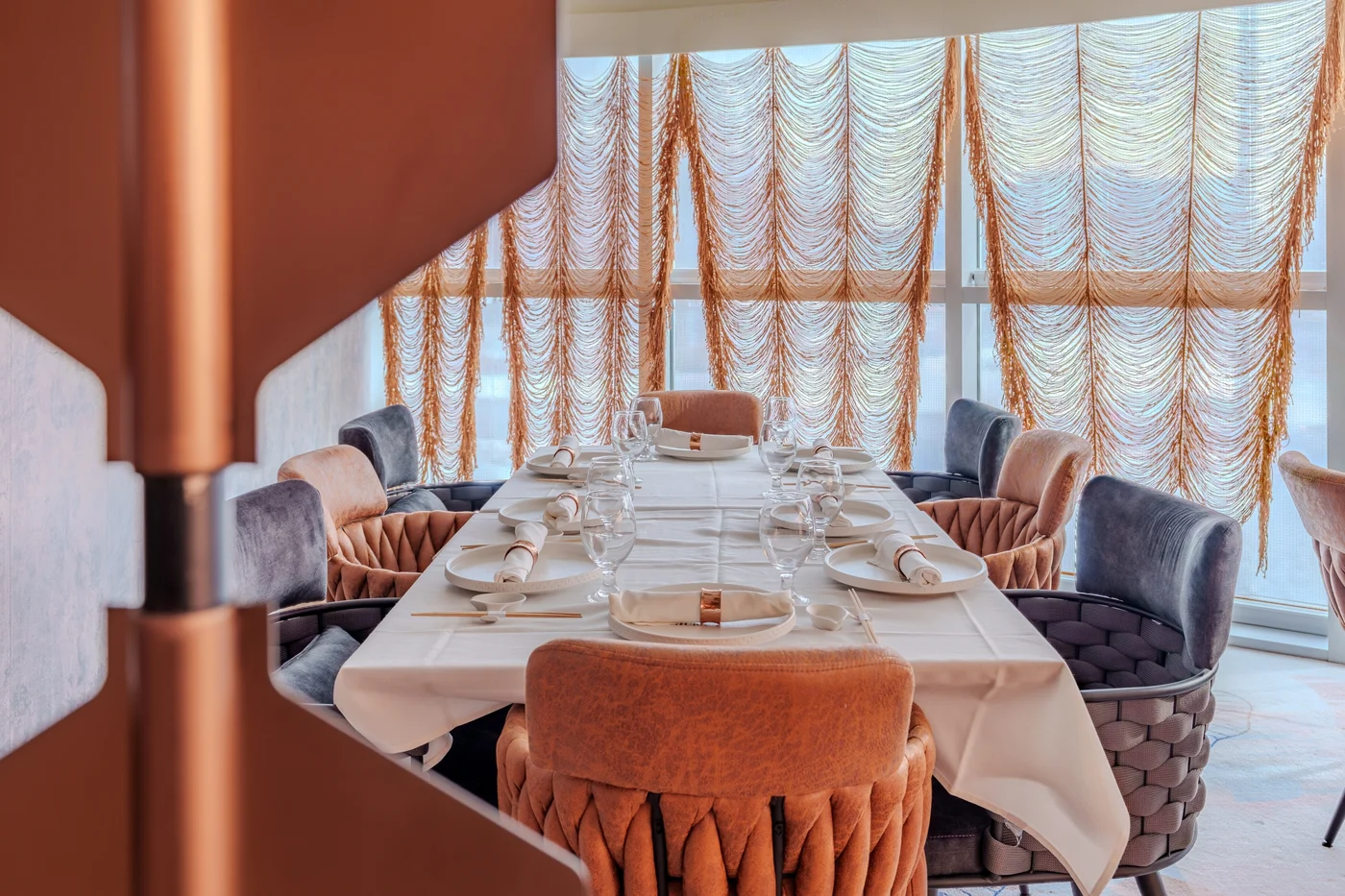 A private dining table at Churasuko, framed by flowing curtains